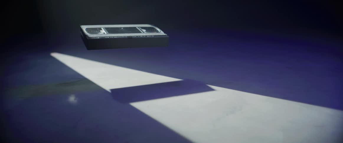 A vhs tape floating up in the air