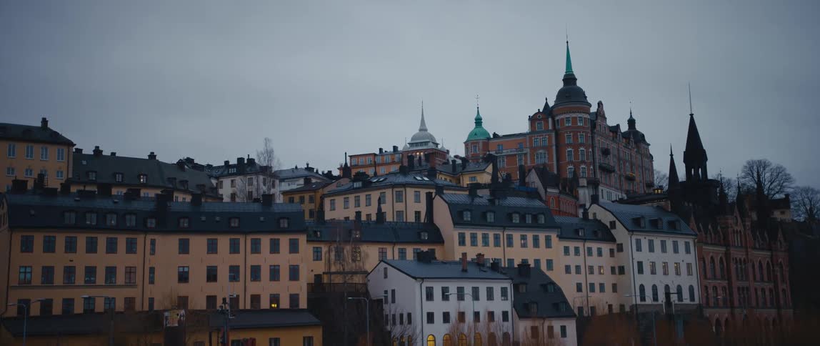 The buildings and spires of stockholm sweden under a cloudy sky