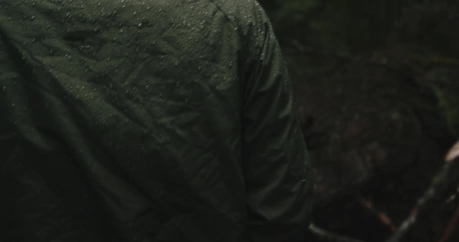 A group of friends hiking in the woods in the rain