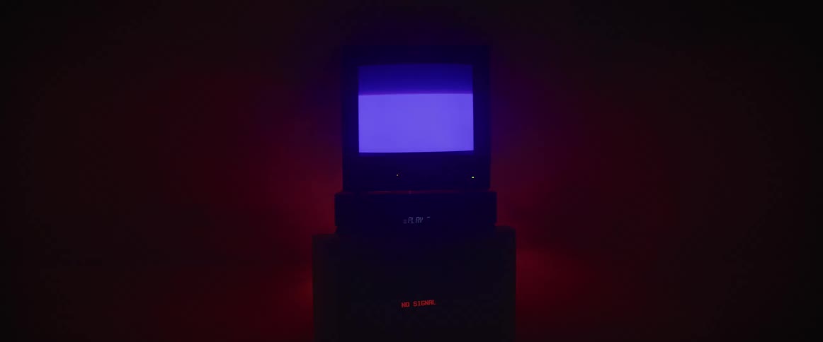 A television displaying static in a dark room