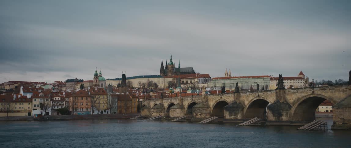 The medieval stone arched Charles Bridge over the River Vltava with views of Old Town Prague, and Prague Castle Complex in the background.