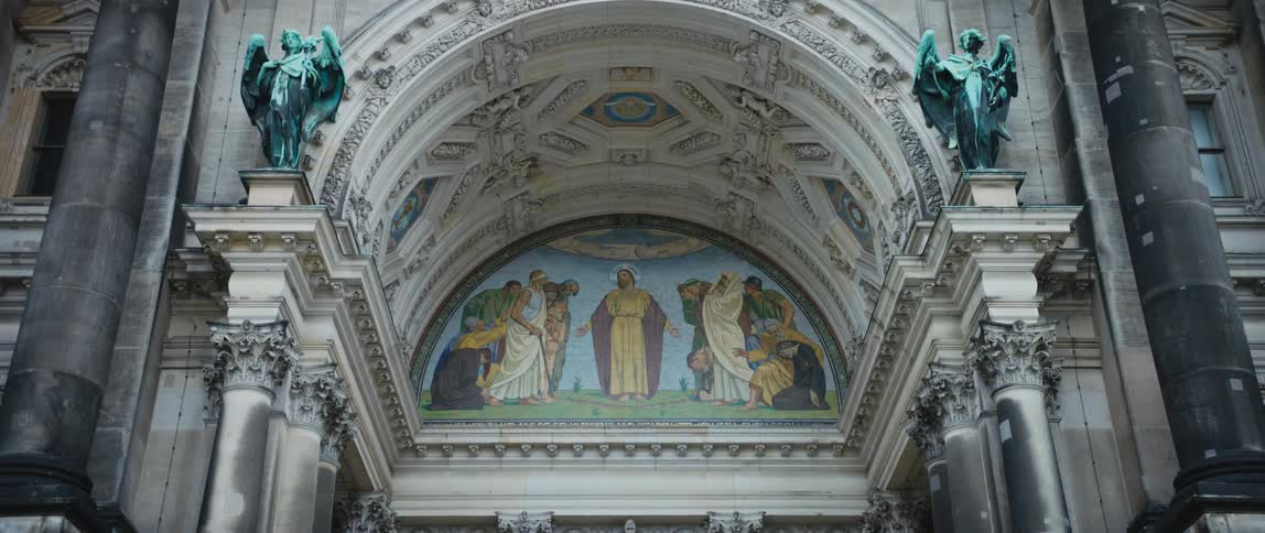 Sculptures and a religious mural adorn the arched entrance to the ornate Berlin Cathedral/Berliner Dom.