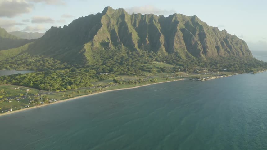 The tall green mountains line the shore
