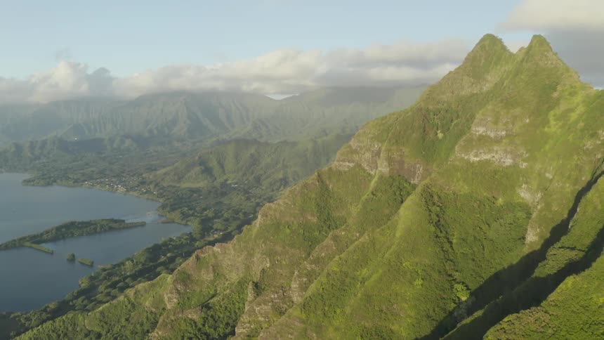 A mountainous coastline covered in vegetation during the day