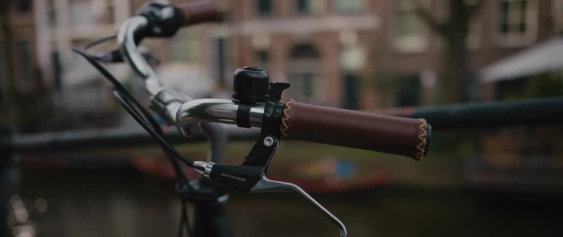 A bicycle is parked in the city of Amsterdam
