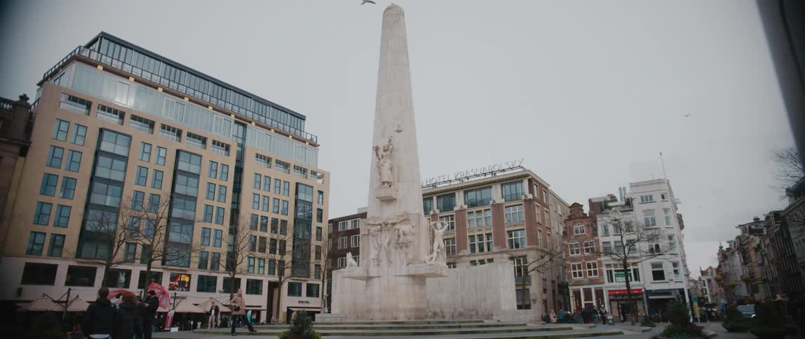People tour around the National Monument on Dam Square, Amsterdam, North Holland, Netherlands