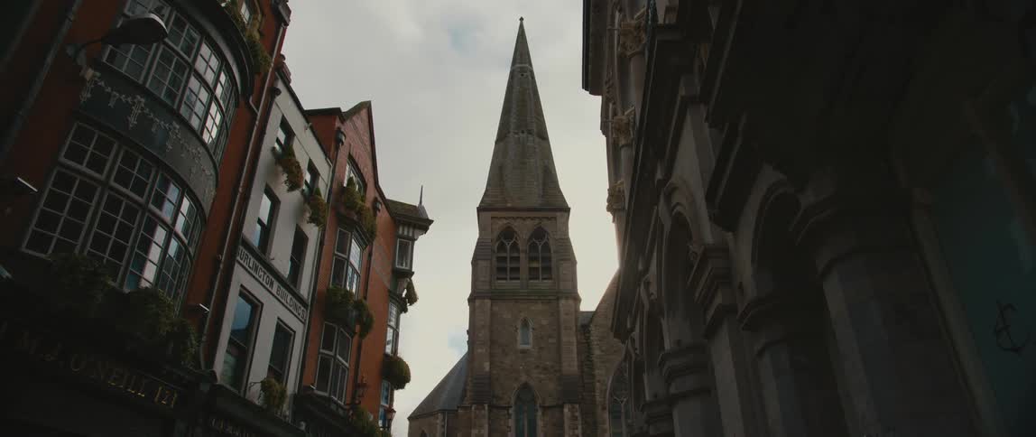 View from the neighborhood street of the steeple tower of St Andrew's Church in Dublin, Ireland