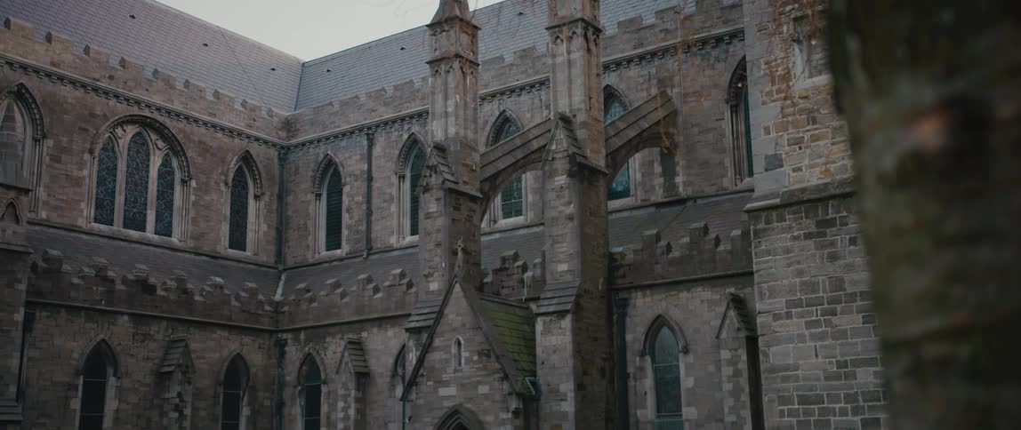 The dual flying buttresses and spires over an arched entrance door to Christ Church Cathedral in Dublin, Ireland