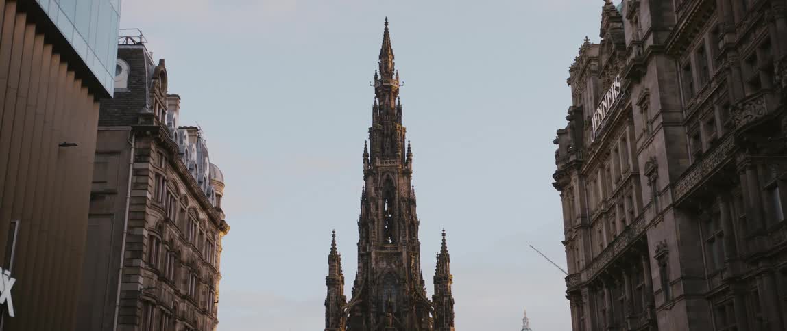 The top of the Scott Monument in Edinburgh, Scotland, United Kingdom flanked by historic buildings