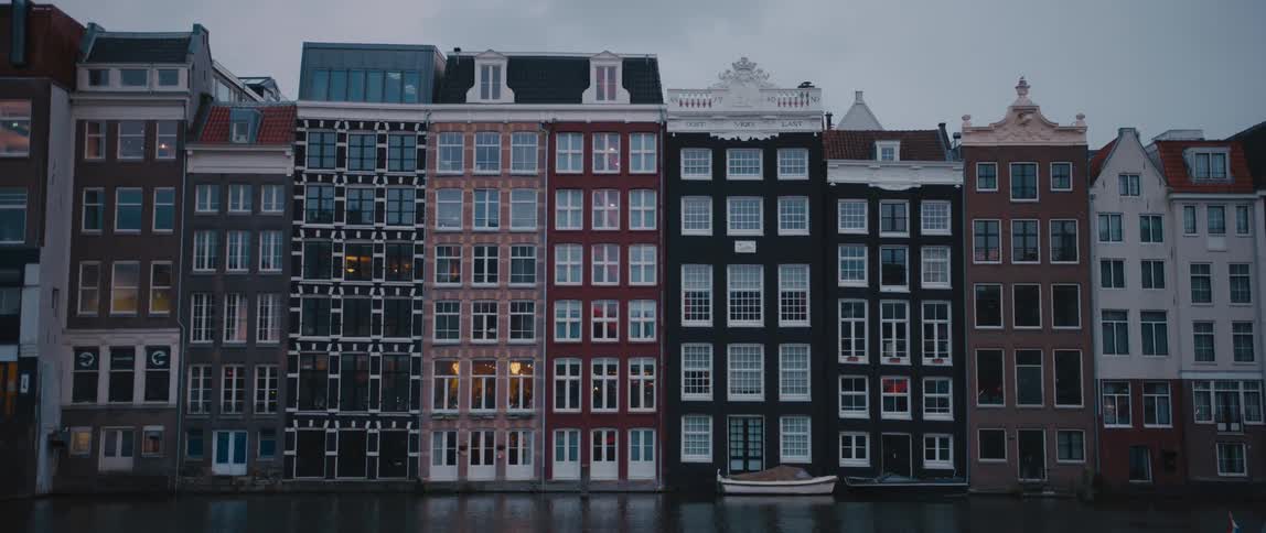 A boat floating on a canal in Amsterdam, North Holland, the Netherlands