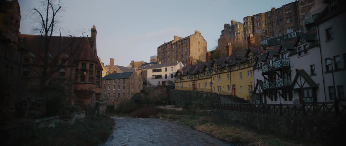 A river flowing through town buildings in the daytime