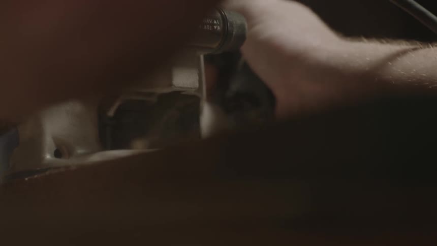Person using a power tool in a workshop