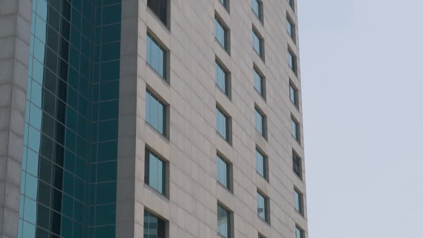 The facade of a skyscraper under a blue daytime sky