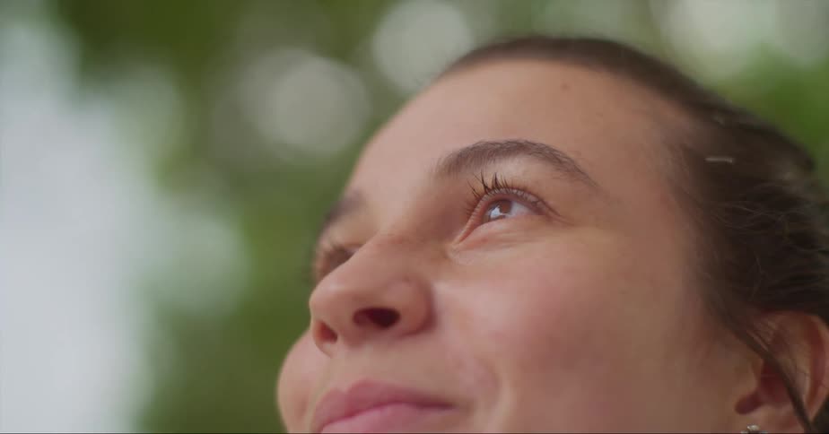 A woman is smiling outside