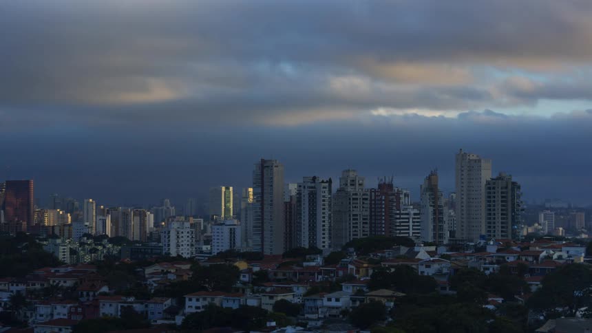 A time lapse of storm clouds moving over high rise office buildings and apartments in a downtown area