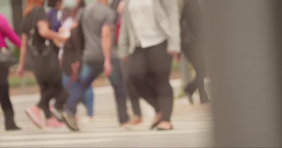 People cross the zebra crossing in town