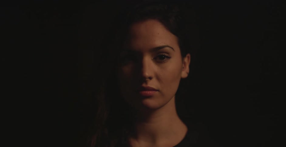 Light shining on woman's face in the dark