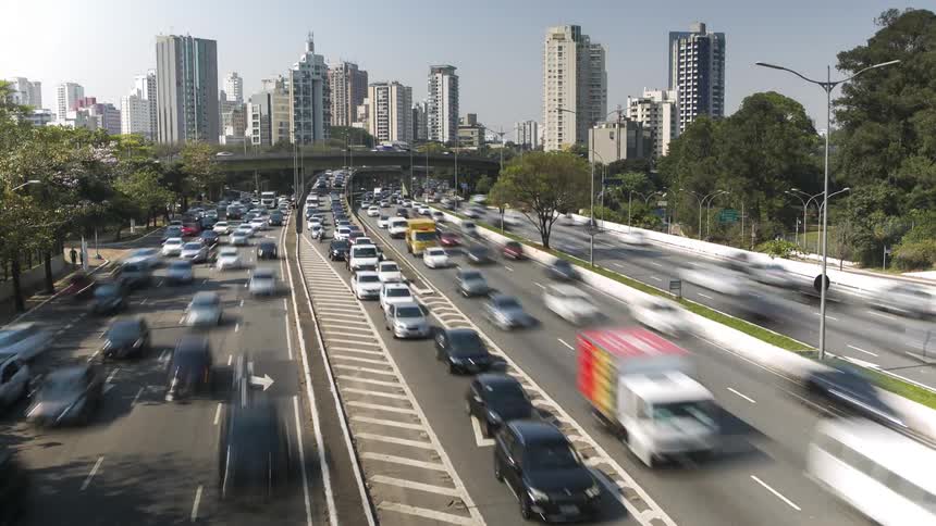 Top view timelapse looking down on countless vehicles travelling along a freeway in major city.