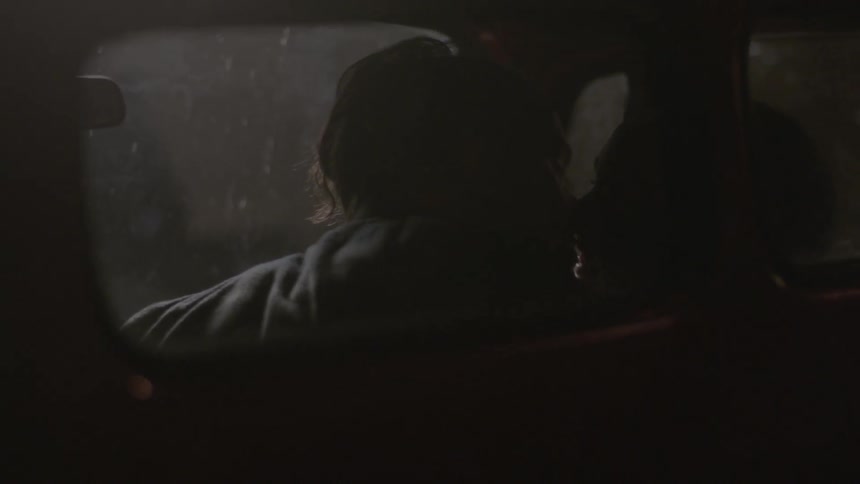 A couple kissing in a pickup truck