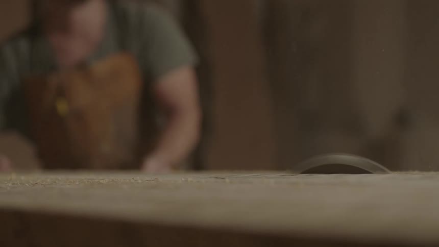 A man saws a block of wood