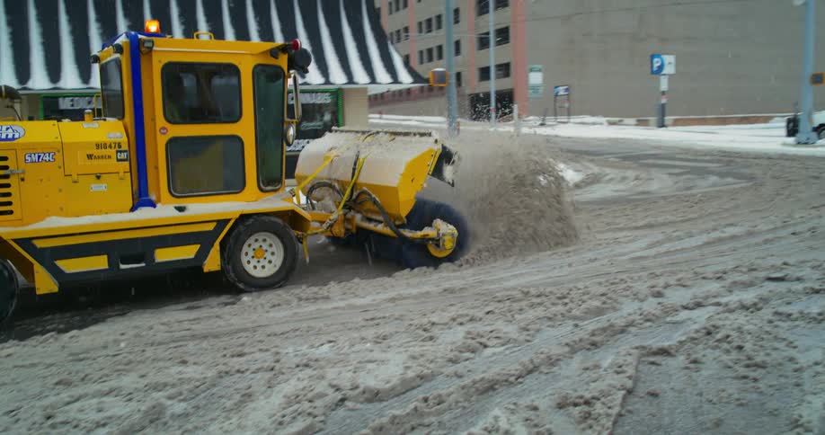 A view of a snow plow moving snow