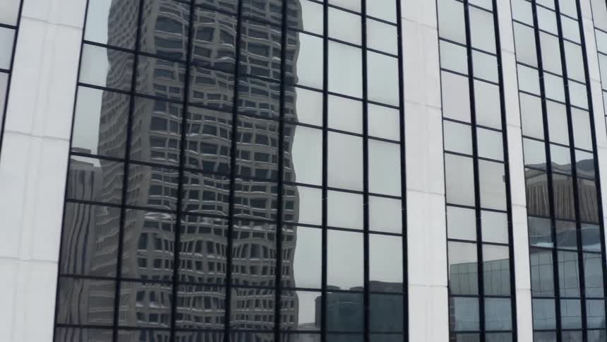 Numerous skyscrapers fill the skyline of a metropolitan area on a snowy day
