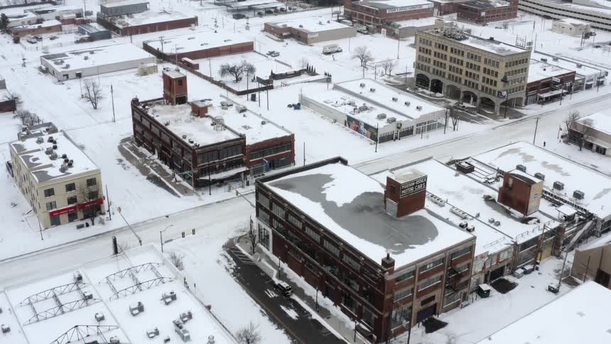 Aerial view of snowy apartment buildings in the city