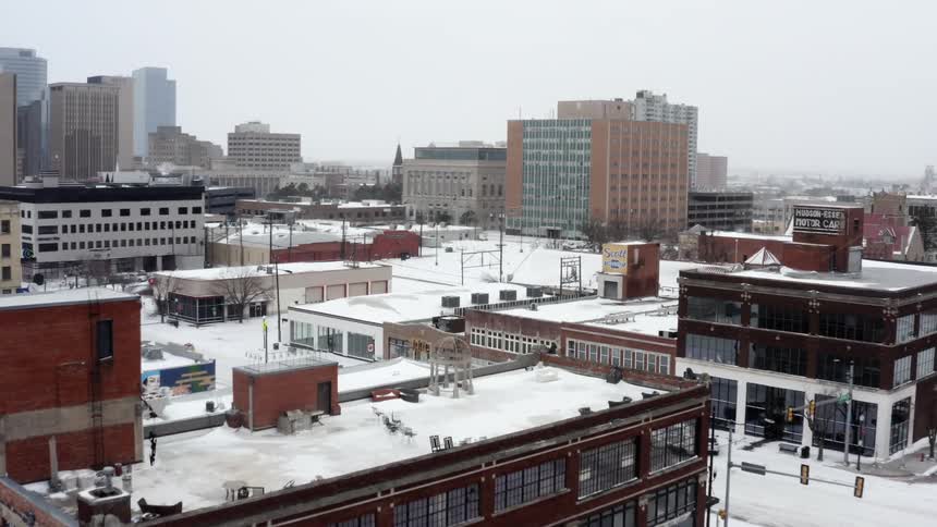 Aerial view of snowy city with apartment buildings