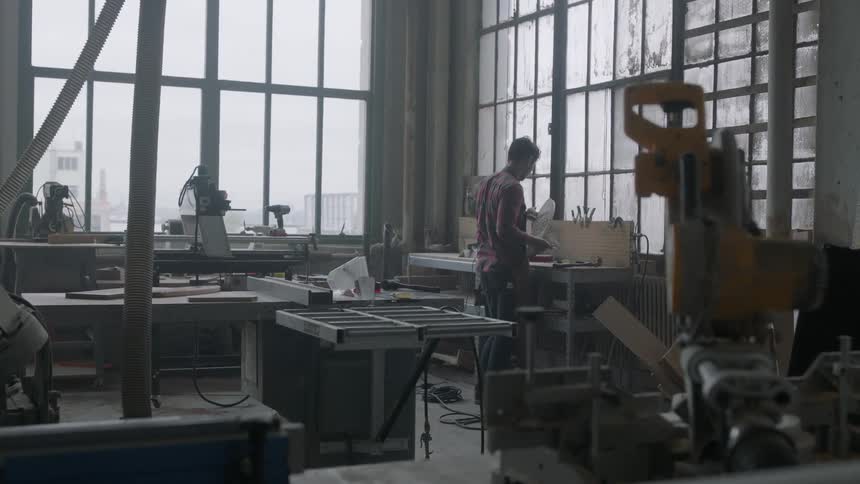 Man inspecting his work in an office