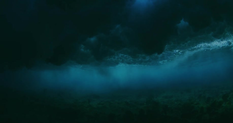 Under water footage of waves crashing above in the ocean