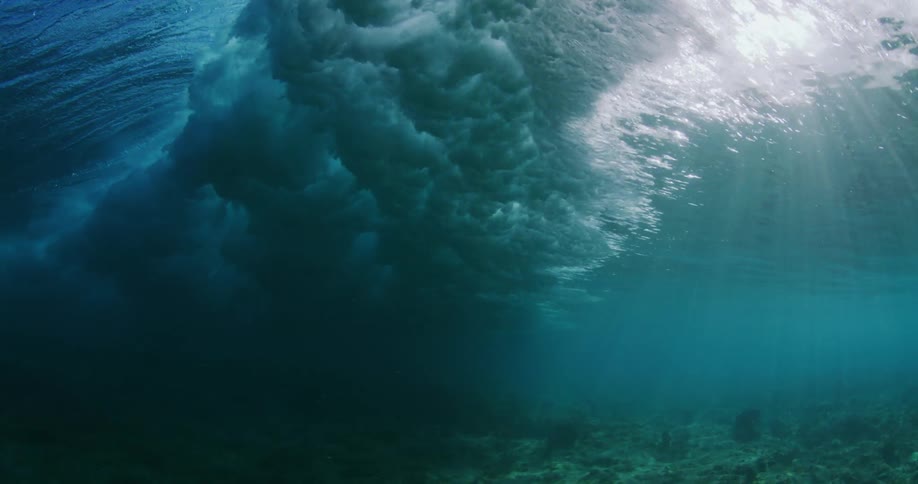 Underwater view of wave crashing above the surface in the ocean