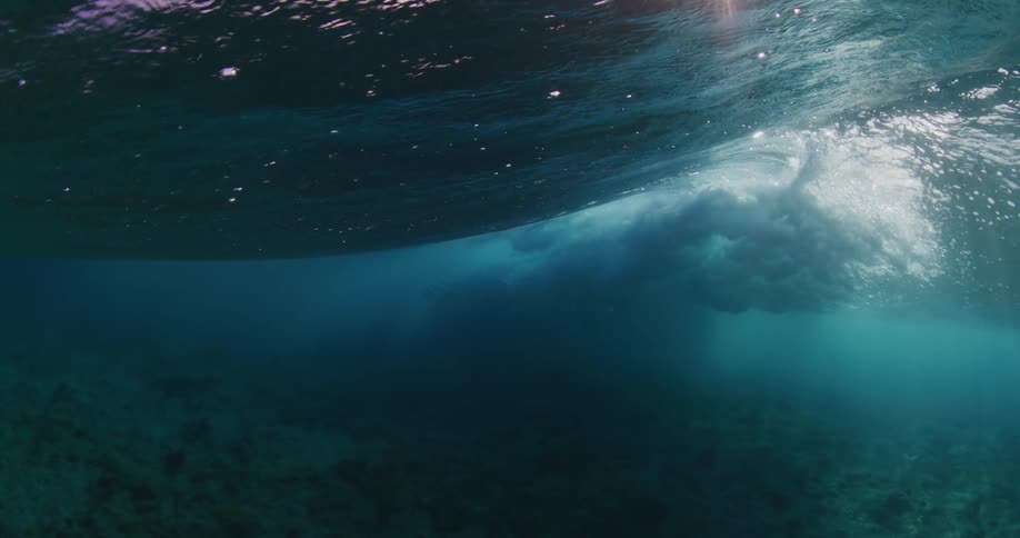 An underwater view of an ocean wave in the sea