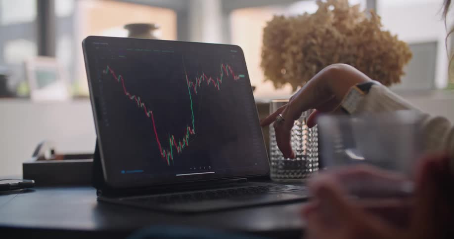 A man and woman looking and pointing at a chart on a tablet