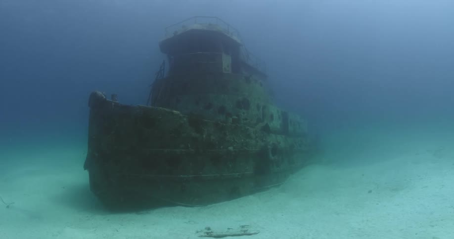 The wreckage of a sunken ship is lying on the seabed