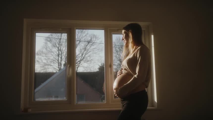 A portrait of a pregnant woman golden hour