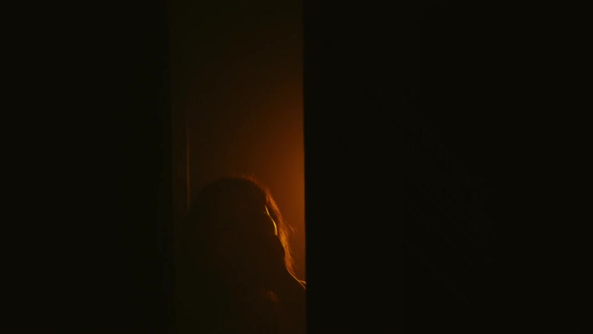 A person is moving at the end of the stairwell