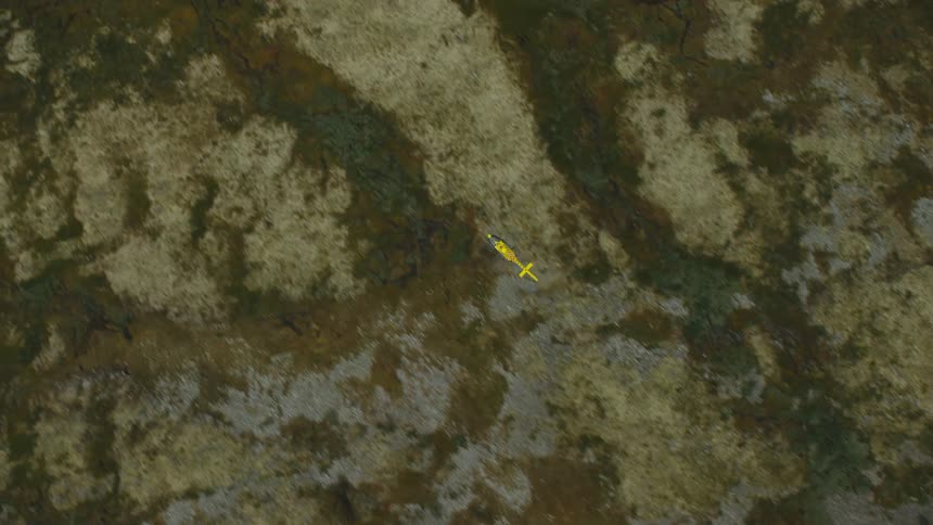 A yellow helicopter flying over land