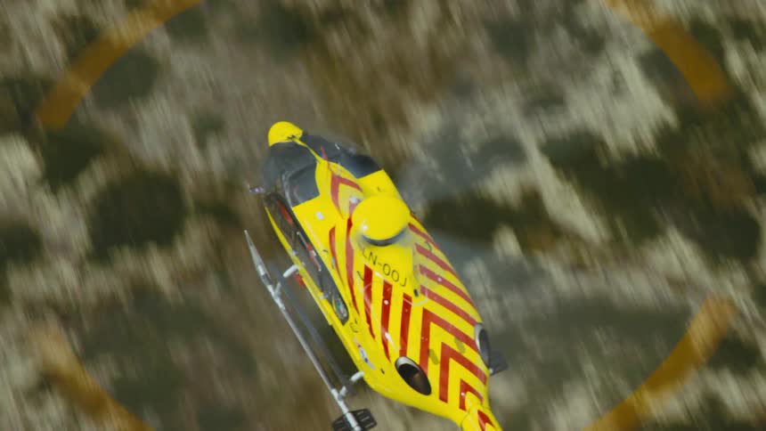 A helicopter flying over the land