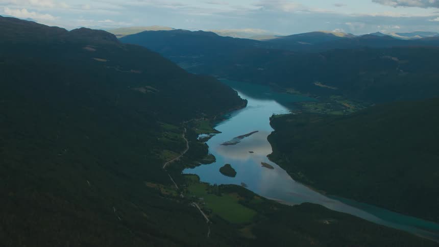 Aerial view of a mountain river valley and mountains in the distance