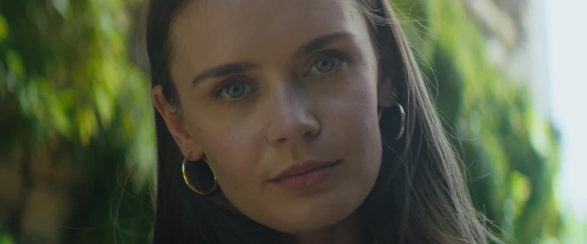A portrait of a woman standing outdoors