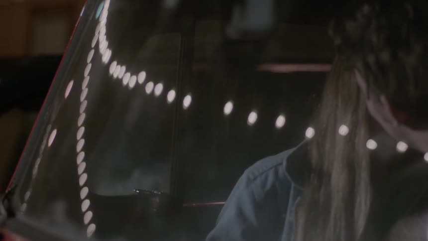 A man and woman make out in a vehicle