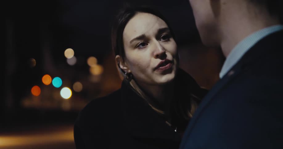 A woman talks to a man then leaves