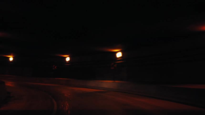 A vehicle passes through the tunnel towards the city