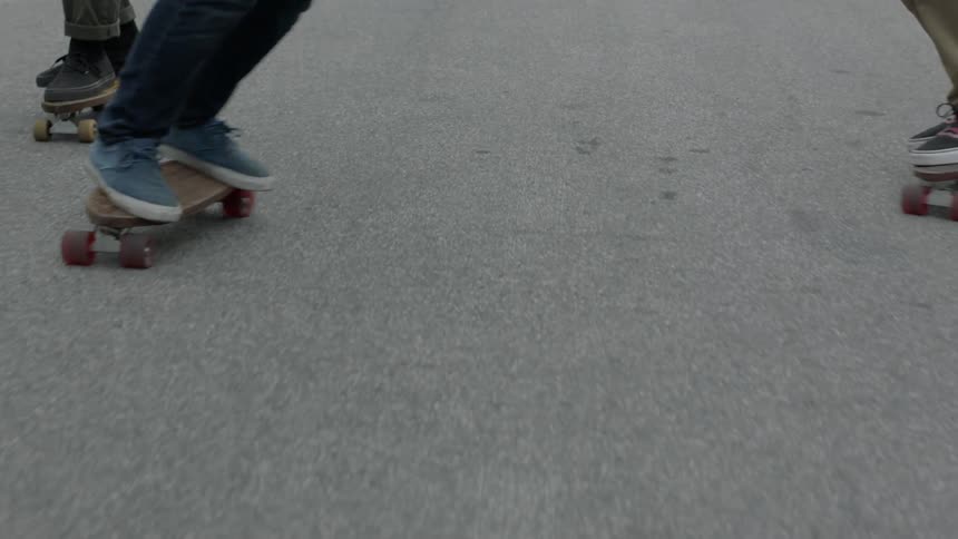 People are skateboarding in the street