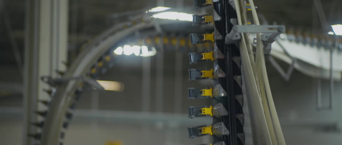 Small conveyor belts move up and down lines in a factory