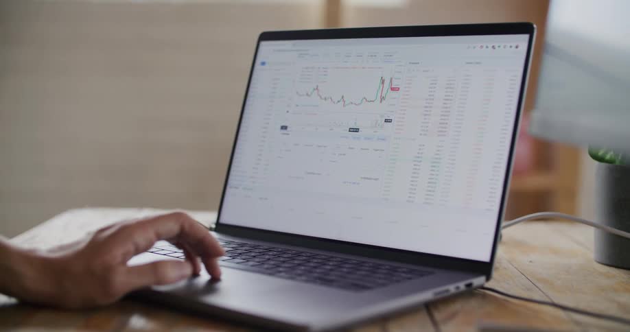 Someone is using a laptop computer and using their fingers to control the mouse