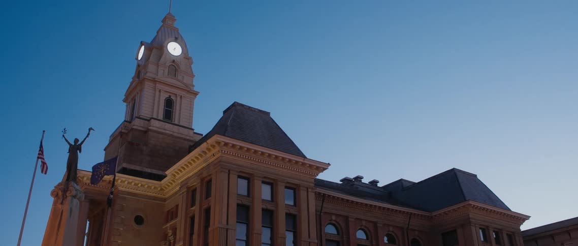 Exterior view of courthouse and clock tower at dusk
