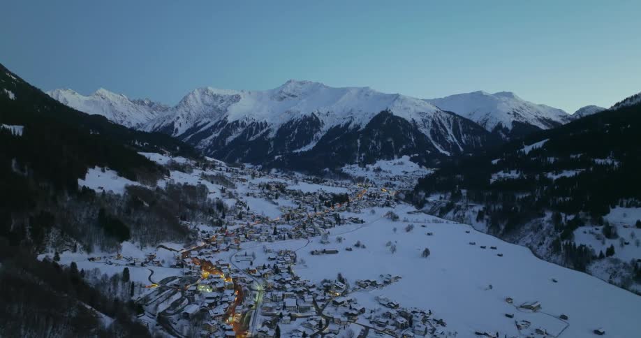 A town in a snowy mountain valley during the day