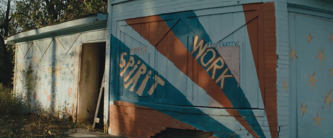 A shipping truck parked outside a shack