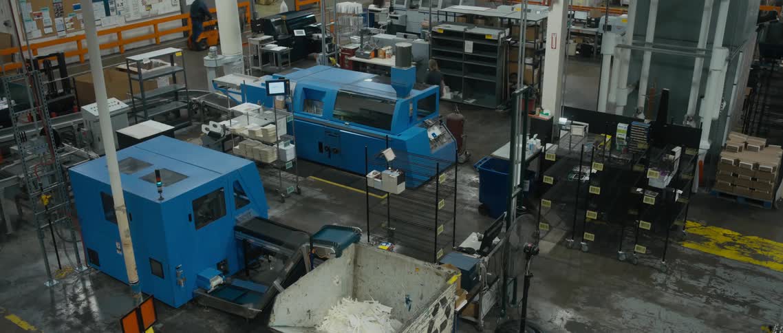 Workers walk around the factory